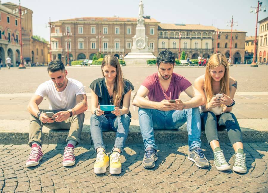 Tourists taking a break and checking their phones