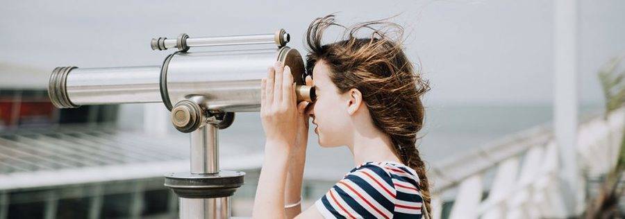 Girl looking through telescope